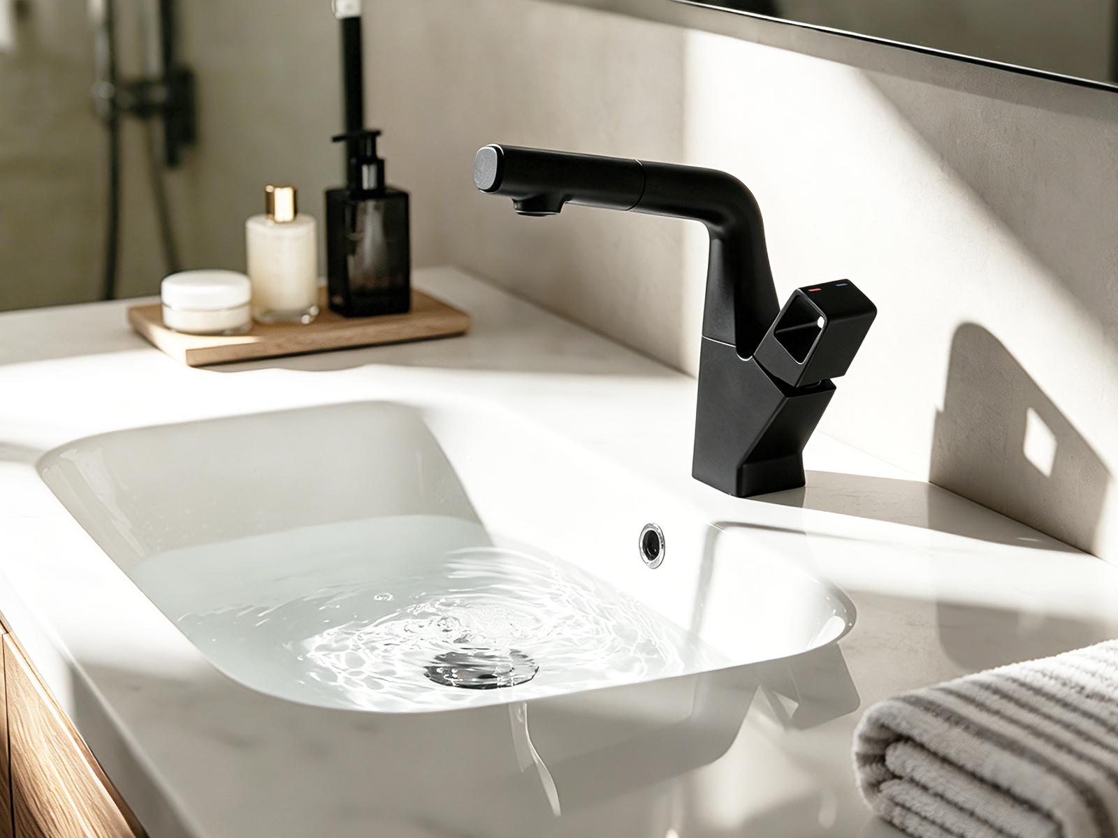 Matte black pull-out basin mixer on a round vessel basin